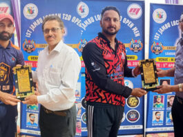 Dignitary presenting player of the match award to a player during post match presentation.