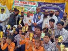 MLA Banihal, Sajjad Shaheen posing along with students during a programme.