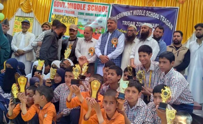 MLA Banihal, Sajjad Shaheen posing along with students during a programme.