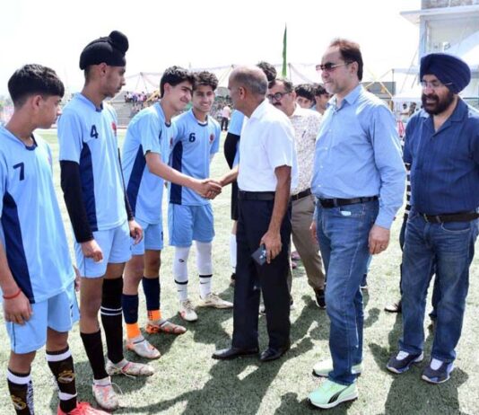 A senior sports officer interacting with young football players at Khel Gaon, Nagrota, Jammu.