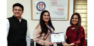 Dignitary receiving memento from management during a programme.