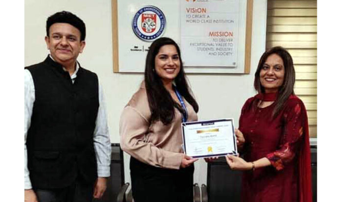 Dignitary receiving memento from management during a programme.