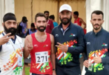 Hansraj posing with support staff during Khelo India Tribal Games in Jagdalpur, Chhattisgarh, after winning a medal.