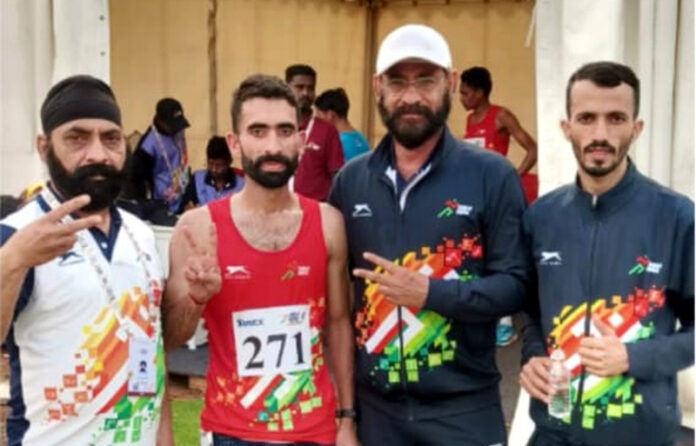 Hansraj posing with support staff during Khelo India Tribal Games in Jagdalpur, Chhattisgarh, after winning a medal.