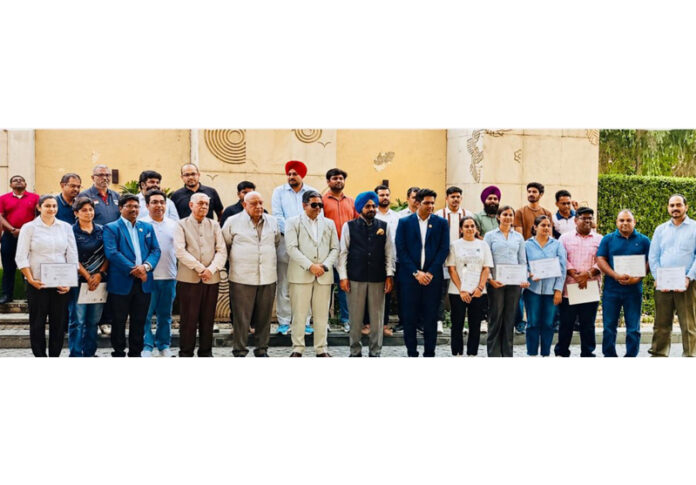 Dignitaries posing along with participants during a programme.