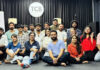 Participants posing for a group photograph during a programme.