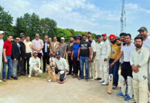 Dignitaries posing along with players during an event.