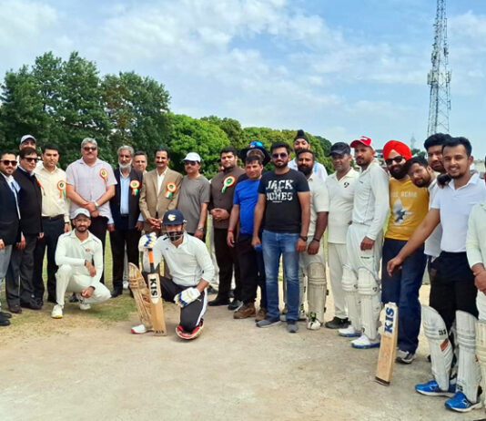 Dignitaries posing along with players during an event.