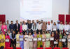Recipients of Research Awards posing along with dignitaries during a programme.