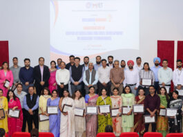 Recipients of Research Awards posing along with dignitaries during a programme.