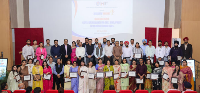Recipients of Research Awards posing along with dignitaries during a programme.
