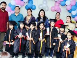 Students posing along with dignitaries and school management during a programme.