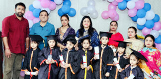 Students posing along with dignitaries and school management during a programme.