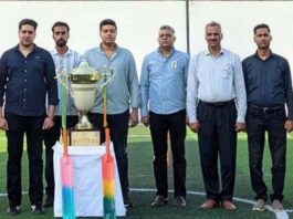 Organizing team of Mega Box Cricket Tournament posing with title trophy.