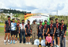 Army organises Volleyball tourney Winners posing with the trophy alongside the dignitary.