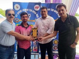 Dignitaries presenting player of the match award during post-match ceremony.