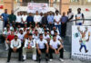 Winning team posing along with trophy during prize distribution ceremony.