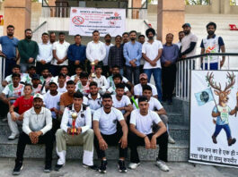 Winning team posing along with trophy during prize distribution ceremony.