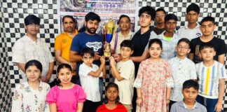 Winners posing along with trophy during a programme.
