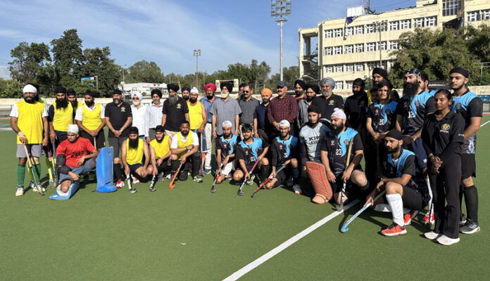 Hockey players posing along with dignitaries during the programme. Hockey players posing along with dignitaries during the programme.