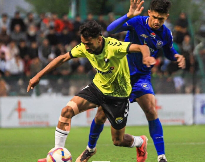 Football players in action during a match in Srinagar.