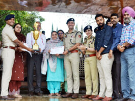 Dignitaries presenting trophy and certificates during a programme.