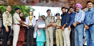 Dignitaries presenting trophy and certificates during a programme.