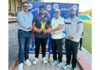Dignitaries presenting award to player of match.