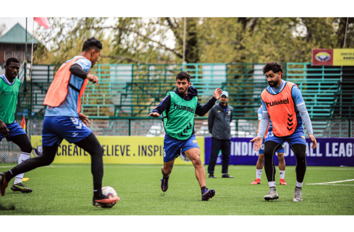 Football players in action during a practice session at TRC Ground, Srinagar.