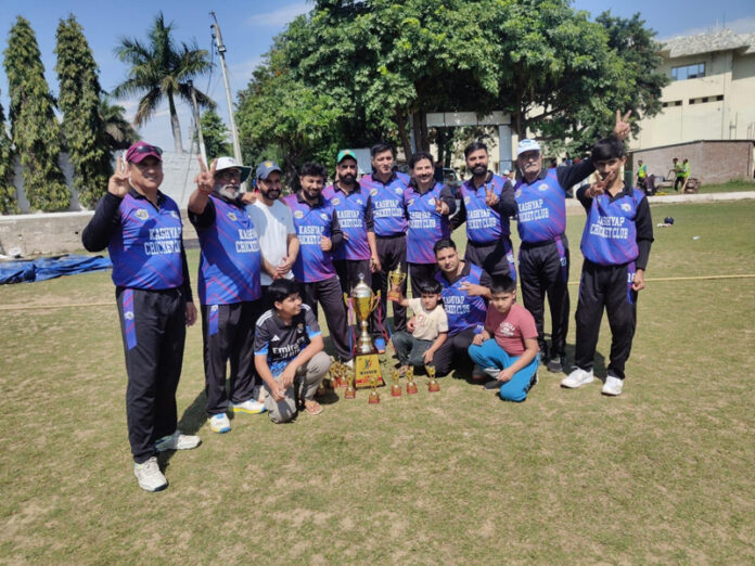 Winning team posing along with trophy.