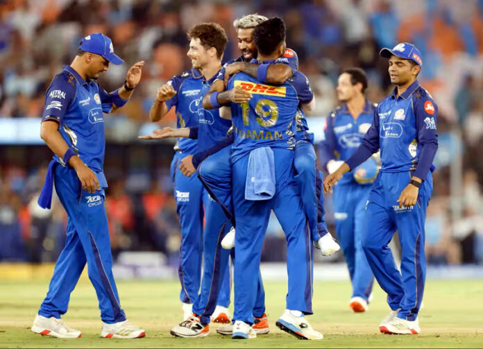 MI players celebrating after defeating Gujarat Titans in Ahmedabad.