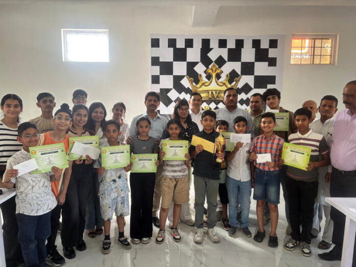 Winners posing along with certificates during a prize distribution ceremony.