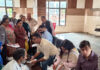 Doctors examining patients at a disease screening camp in Ramnagar, Udhampur on Saturday.