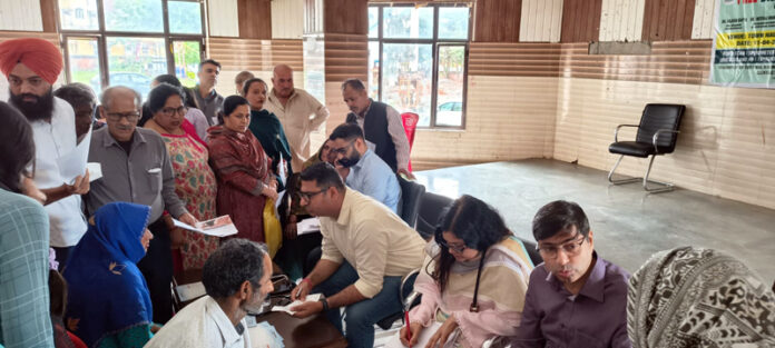 Doctors examining patients at a disease screening camp in Ramnagar, Udhampur on Saturday.