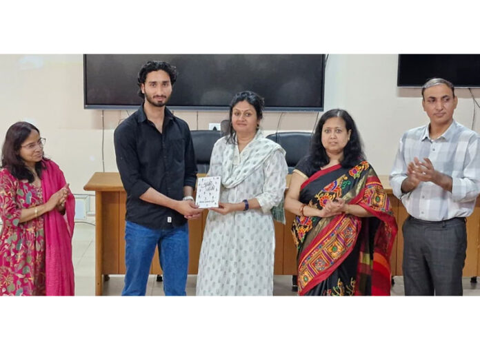 Key note speaker being presented memento during awareness programme at SMVDU.