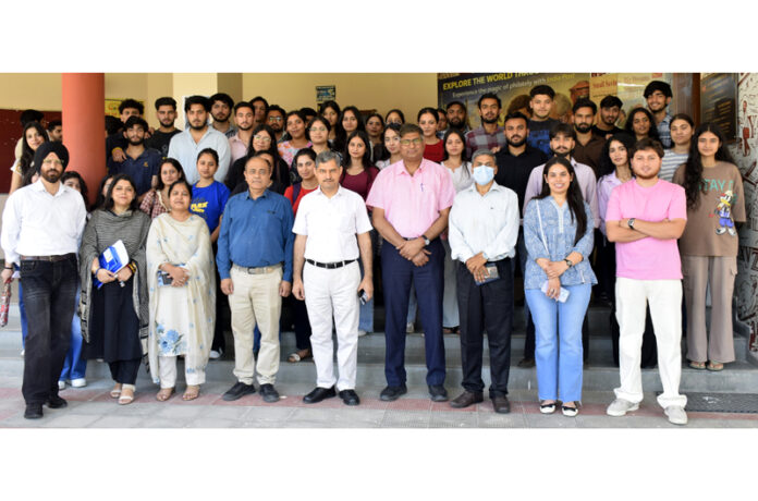 Dignitaries posing along with participants during a programme.