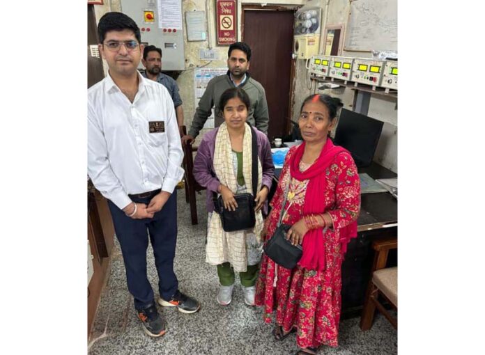 Railway staff returning lost bag to owner passenger.