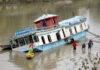 Partially sinked houseboat near Zero Bridge on the Jehlum river in Srinagar on Wednesday. —Excelsior/Shakeel