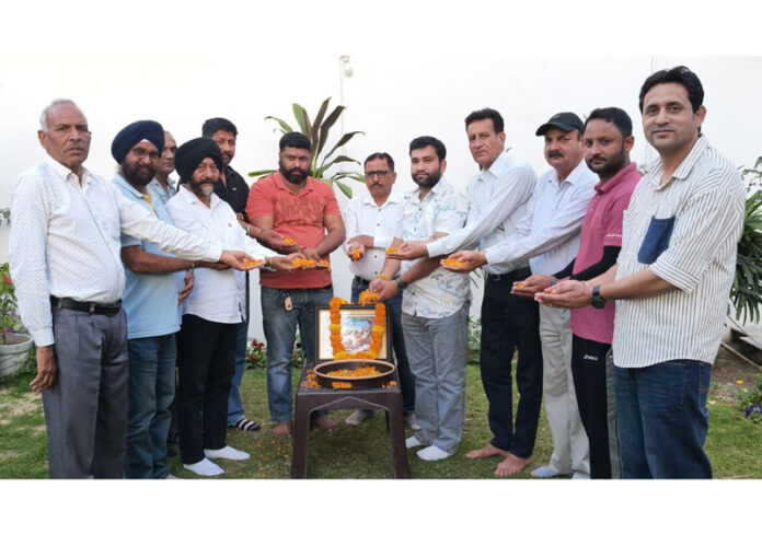 Former Minister Manjit Singh paying floral tribute to Sant Dhanna Jatt on Tuesday.