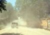 A vehicle moves through dust and high air pollution on a Rajouri road. —Excelsior/ Imran