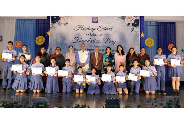Students posing along with school management during a programme. Students posing along with school management during a programme.