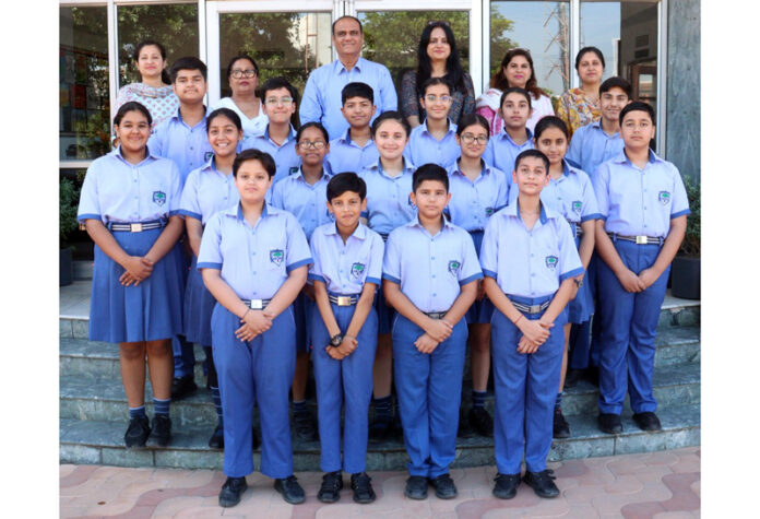 Students posing along with school management.