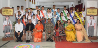 Students posing along with dignitaries during a programme.