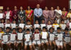 Students posing along with certificates during a programme.