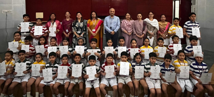 Students posing along with certificates during a programme.
