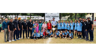 Winning team posing along with dignitaries during a programme.