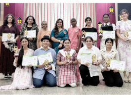Students posing along with dignitaries during a programme.