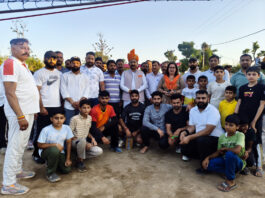 Winning team posing along with dignitaries.