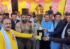 MLA Ramban Arjun Singh Raju presenting trophy to the winner wrestler.