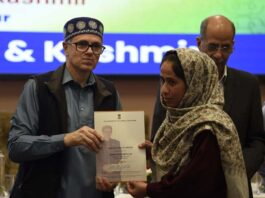 Chief Minister Omar Abdullah giving appointment letter under the Rehabilitation Assistance Scheme at SKICC, Srinagar on Thursday. -Excelsior/Shakeel